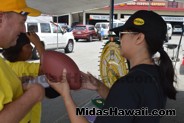 Throw the football in the Tire contestant at the Drive Out Hunger Kickoff Event Midas Hawaii Oil Change Auto Repair 024