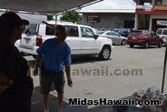 Customer trying his luck at a game at the Drive Out Hunger Kickoff Event Midas Hawaii Oil Change Auto Repair 035