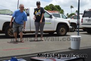 Staff encouraging a winner at the  Drive Out Hunger Kickoff Event Midas Hawaii Oil Change Auto Repair 040