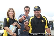 Wayne Rhoden with Midas owners Bob and Dianne Pereira having fun getting organized for refreshments.